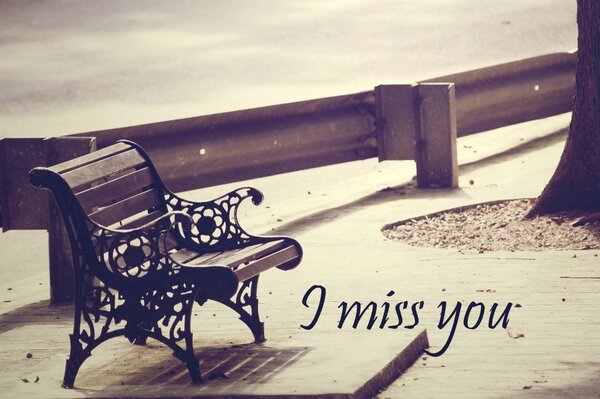 Black and white image of a lonely park bench