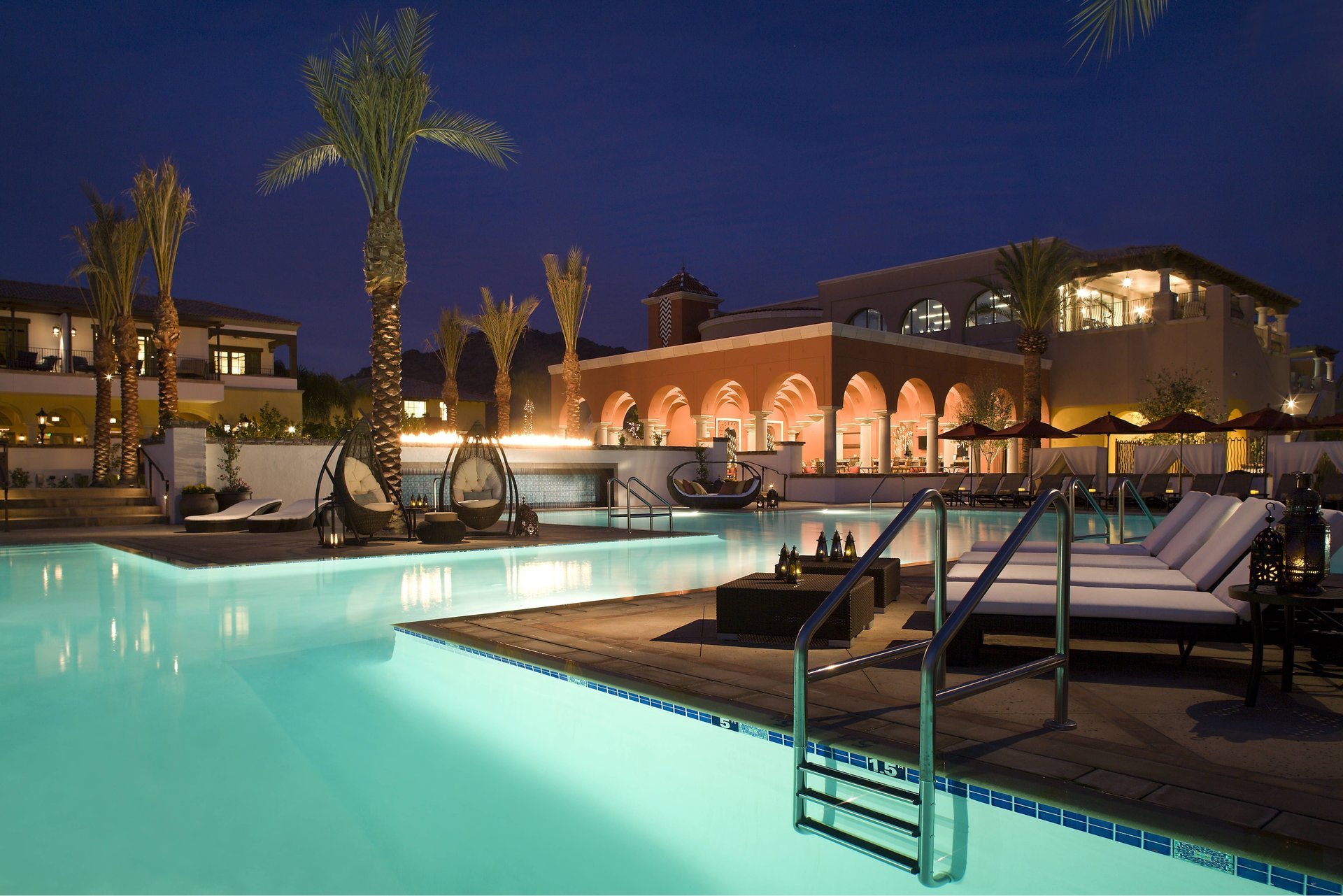 pool house lanterns sunbeds night palm tree