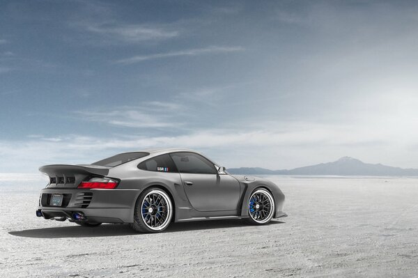 Silver Porsche in the desert side view