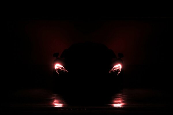 Sports car headlights in complete darkness
