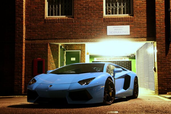 Blue lamborghini aventador pulls out of the parking lot