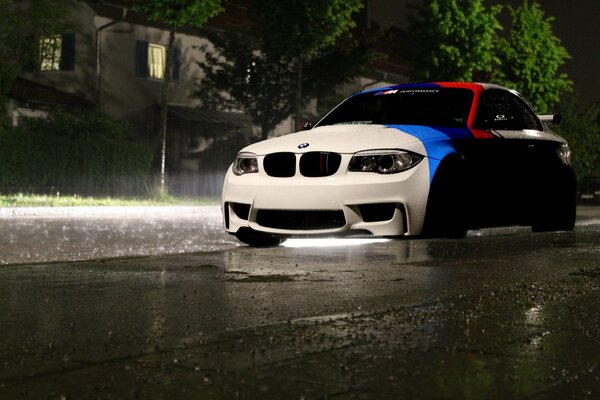 Striped bmw in the rain of the night city