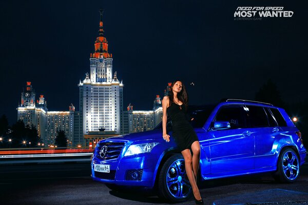 Beautiful girl next to a blue Mercedes