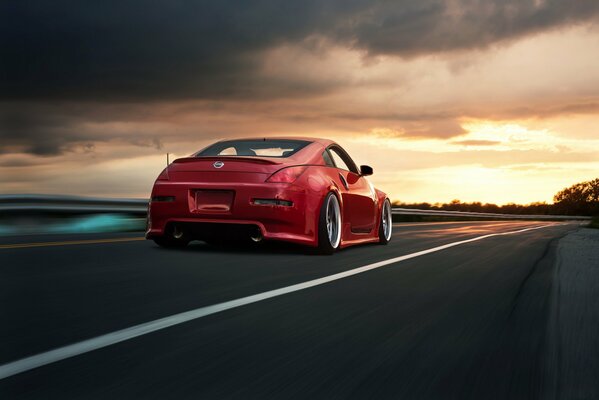 Red Nissan 350z on the evening road