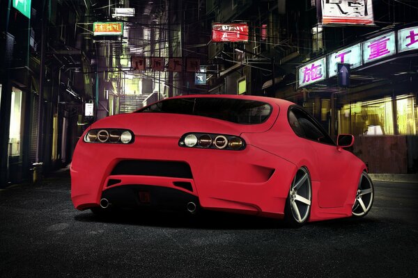 Toyota supra en rojo en medio de la ciudad nocturna