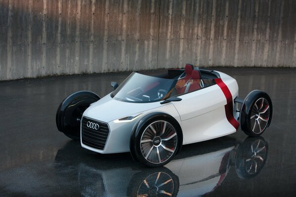 An unusual little white car with an open roof