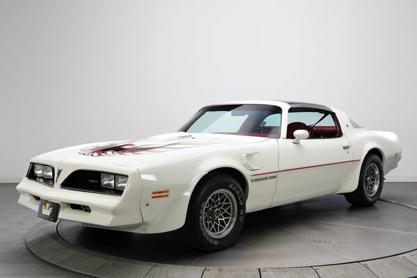 Retro white car on the exhibition podium