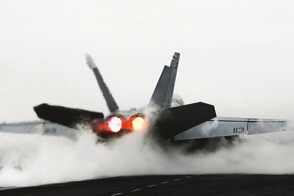 Fighter jet releases smoke on the ground