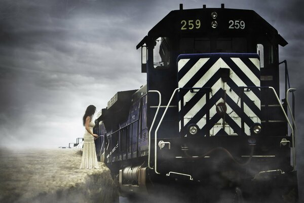 A girl in white approaches a black train