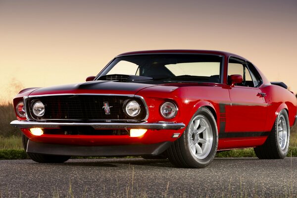 Red ford mustang boss 302 on the road