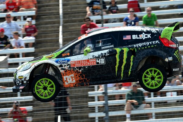 Racing Ford against the background of people sitting on the podium