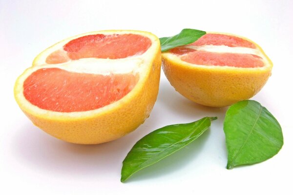 Grapefruit with three leaves on a white background