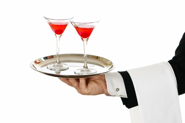 The waiter s hand holds a tray with two glasses