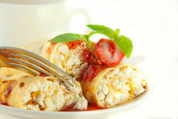 Pancakes with cheese with strawberry sauce