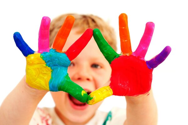 A boy with hands in bright colors