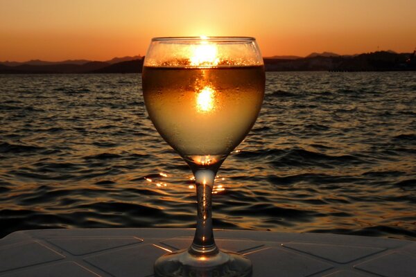 A look at the sunset through the prism of water in a glass