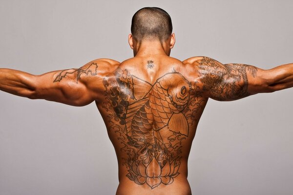 Cool tattoo on a man s strong back