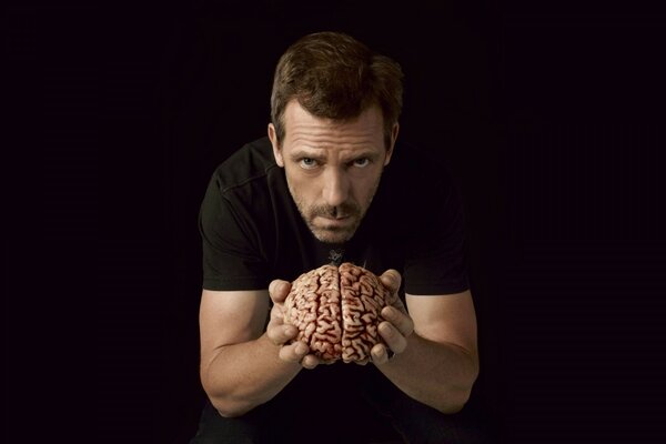 Dr. House photo with a brain in his hands