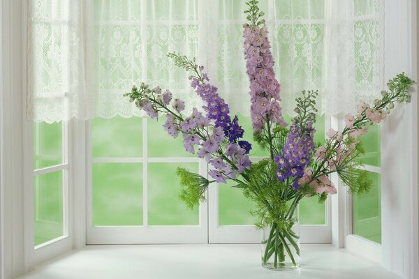 Bouquet of flowers on a white window