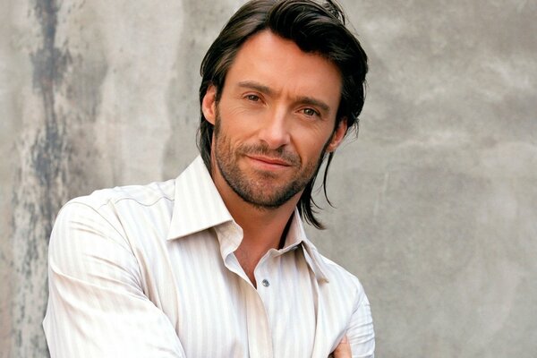 Photo of Hugh Jackman on a gray concrete background