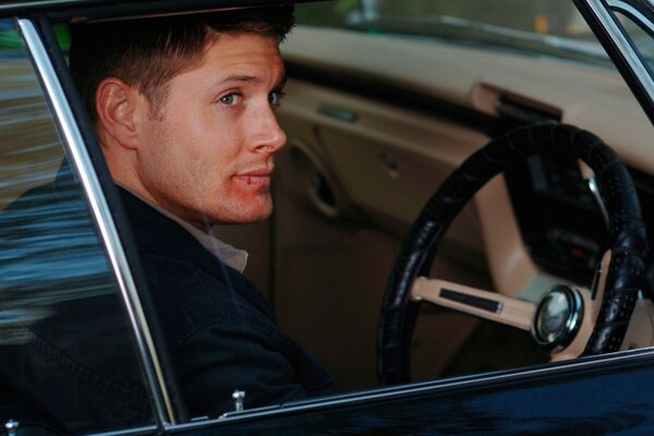 Actor Jensen Ackles sits behind the wheel of a car