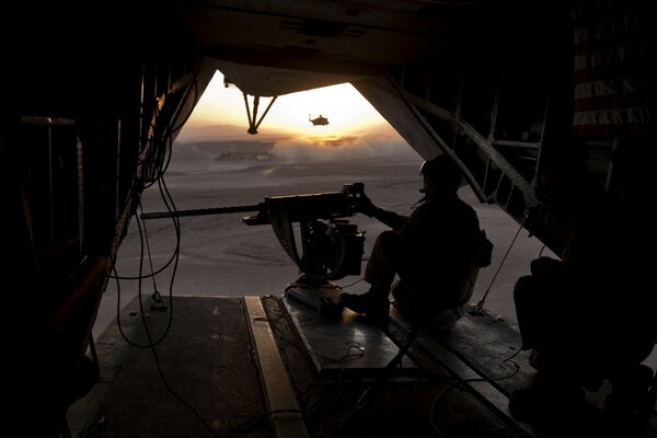 Soldiers on a helicopter ready to shoot