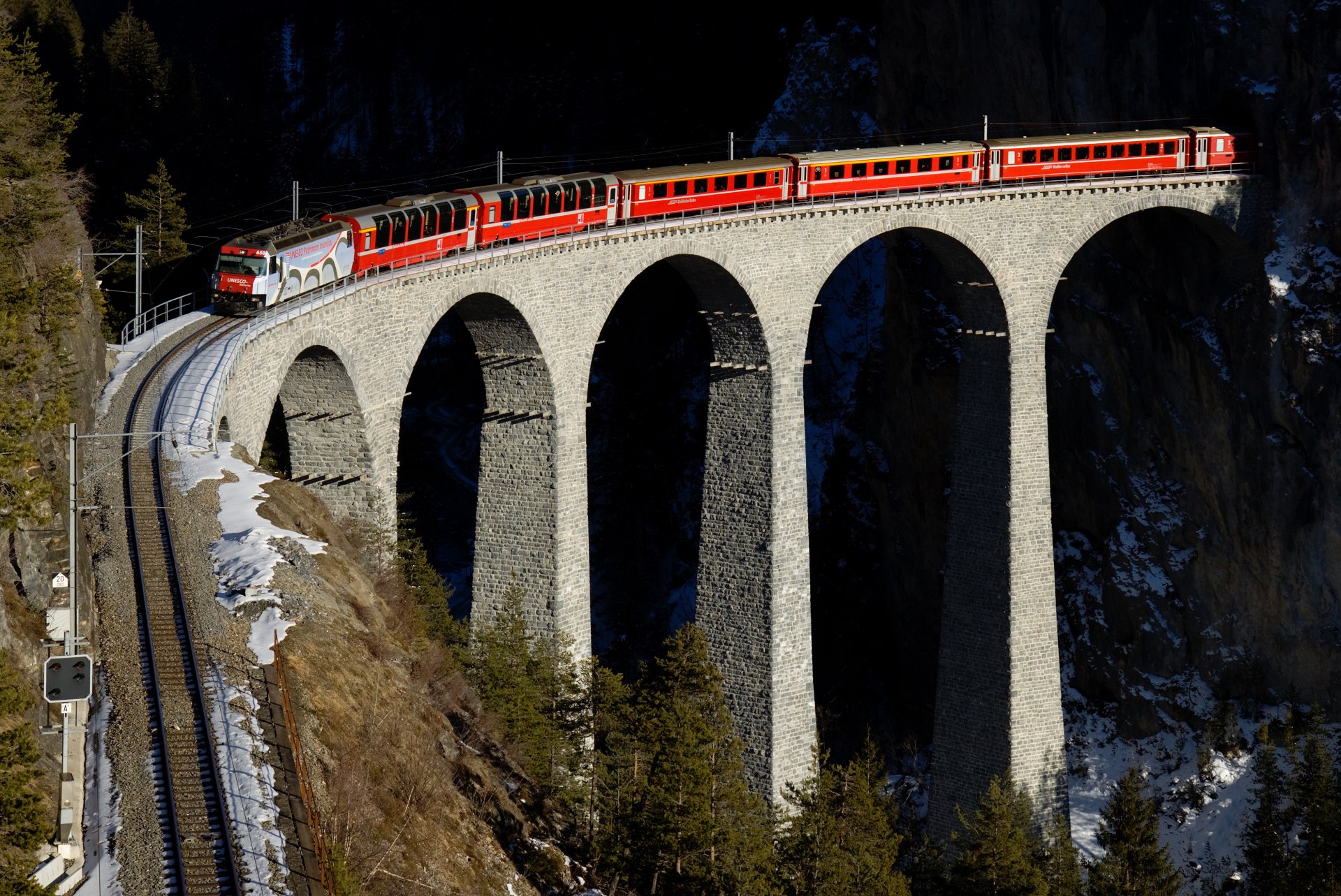 train red railroad mountain viaduct bridge switzerland