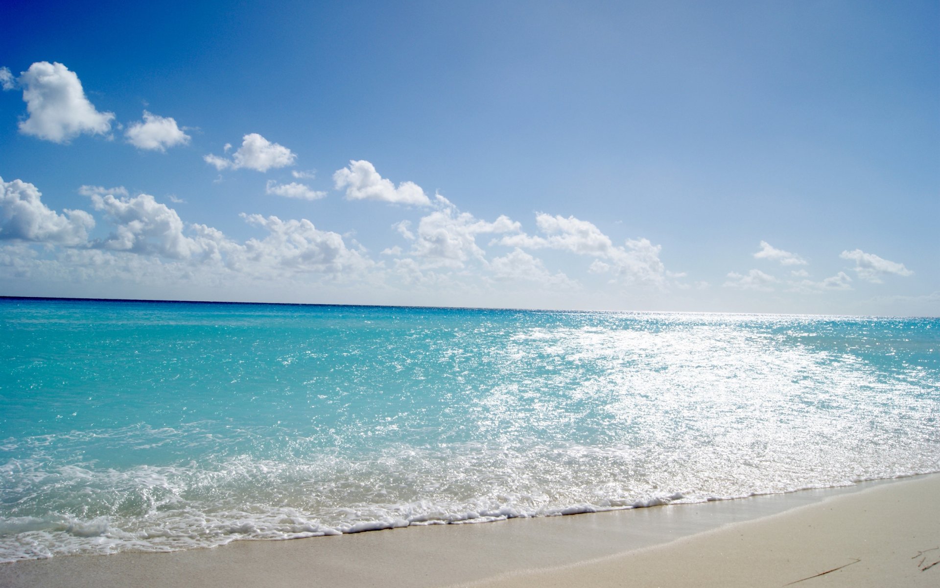 mare acqua onde blu costa spiaggia sabbia cielo nuvole sole caldo estate luce scintillio paesaggio