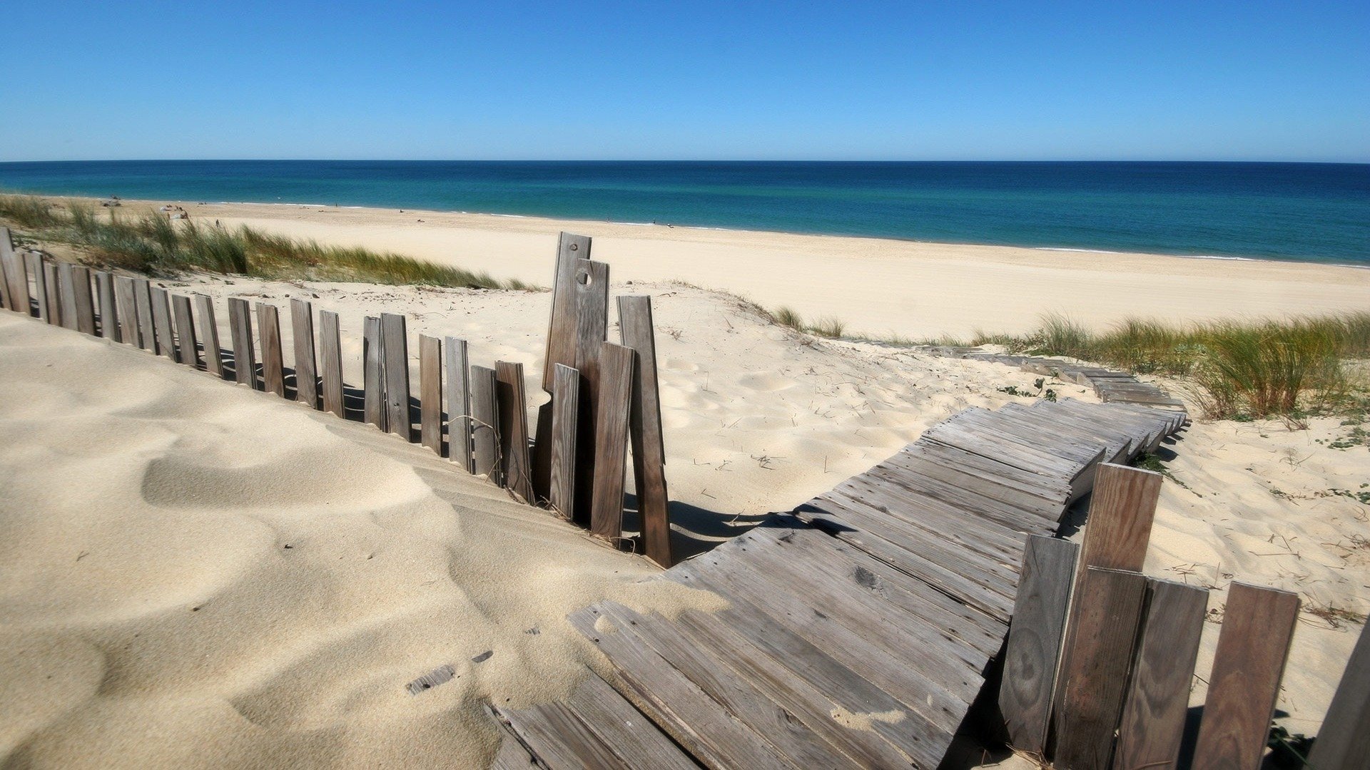 playa valla de madera y el océano azul