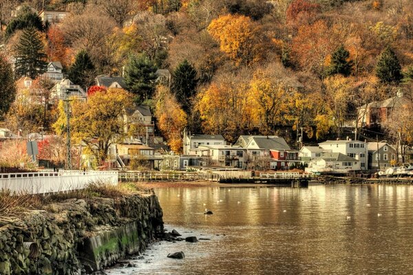 Autumn village on the river bank