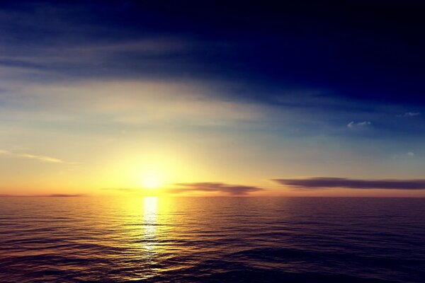 The morning sun rises over the sea