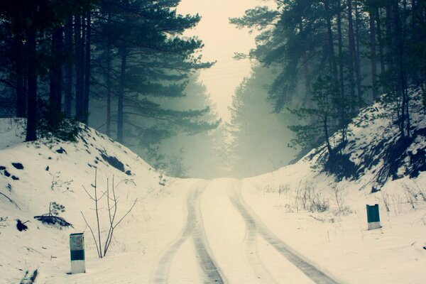 Route enneigée dans la brume brumeuse