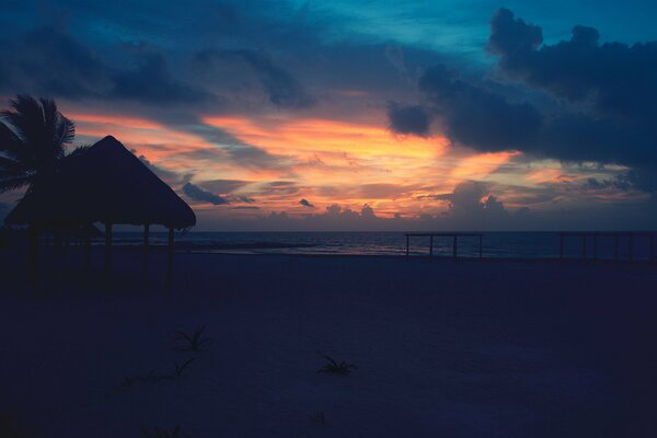 Night beach illuminated by the departing sun