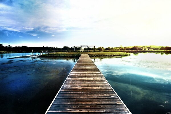 Wooden bridge over the water surface