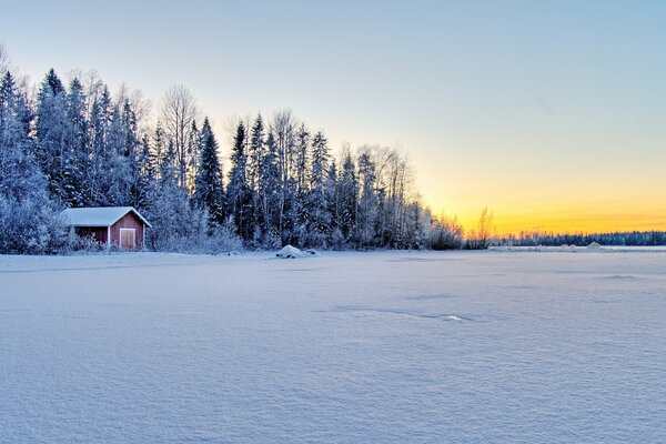 Sunset on the shore of a frozen lake