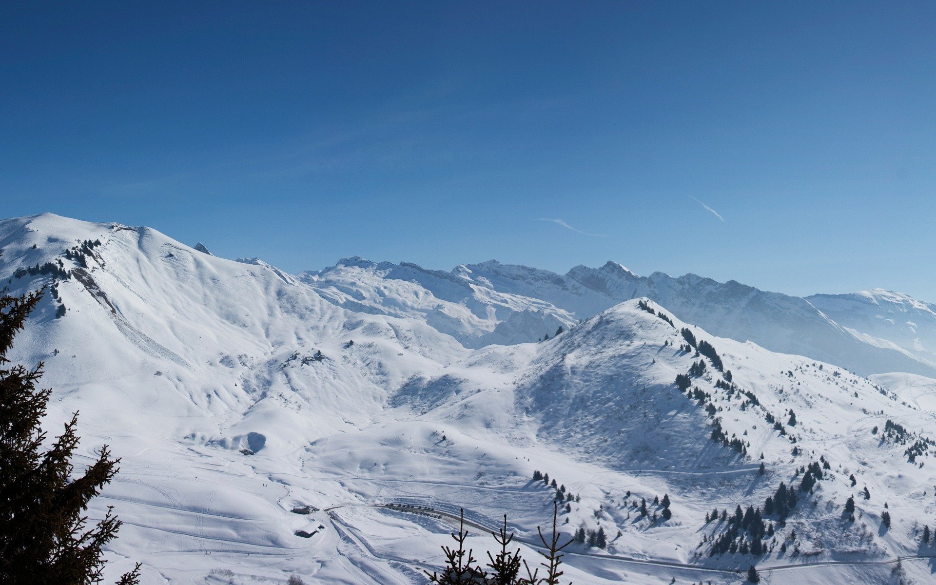 now-capped mountains winter sky