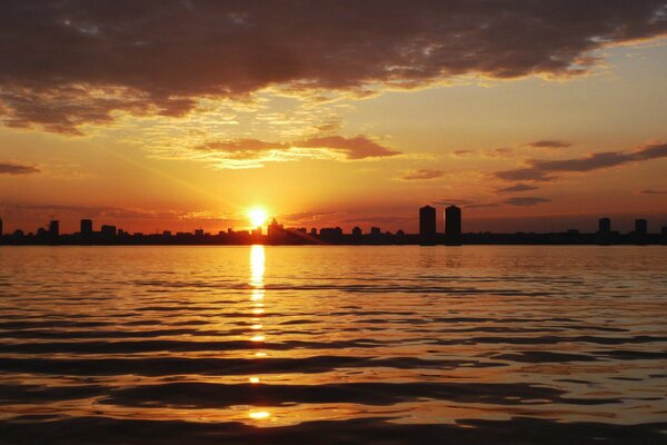 A big city on the background of a burning sunset