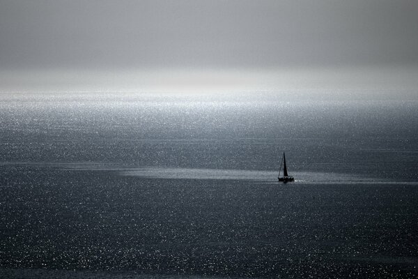 A small boat floats on the waves