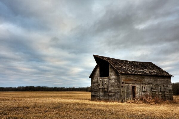 An empty house under thick clouds