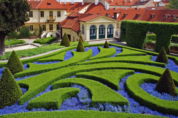 Design of a playground with flowers and shrubs near the house