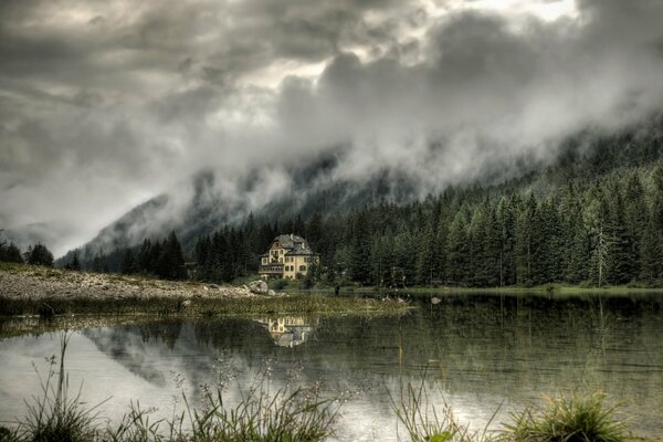 A house in the forest on the lake shore