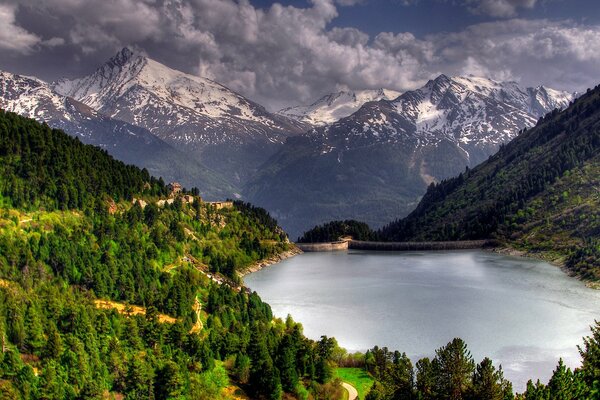 A lake located between forests and mountains