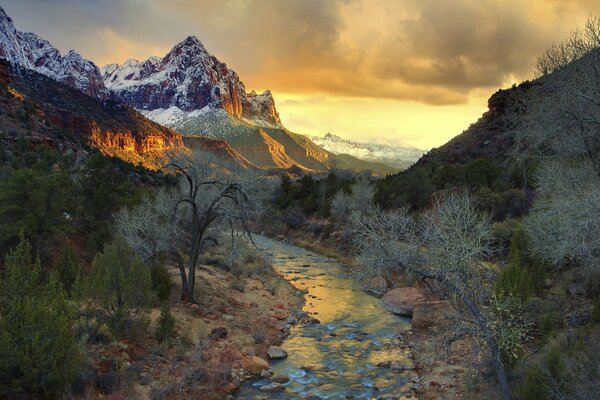 Mountain river at sunset. A mountain on the horizon