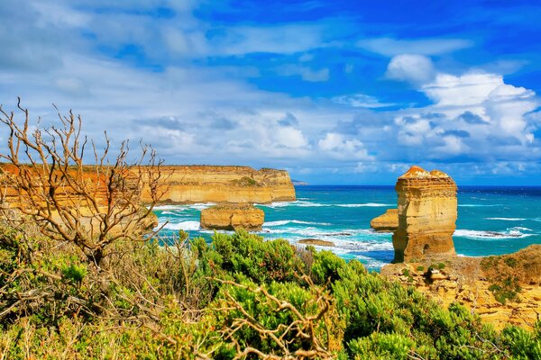 Blue sea, sky and clouds. Rocks on the horizon background