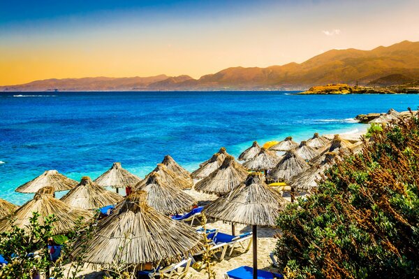 Beach with sun beds and umbrellas by the sea