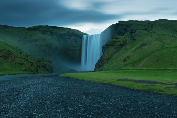 Beautiful waterfall in the rock and clouds