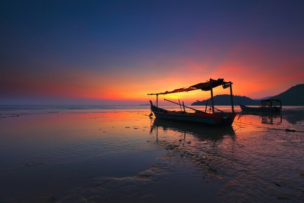 Dawn at sea with a broken boat