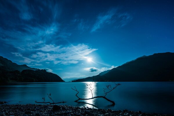 Moon clear water of the lake in which the mountains of Scotland are reflected