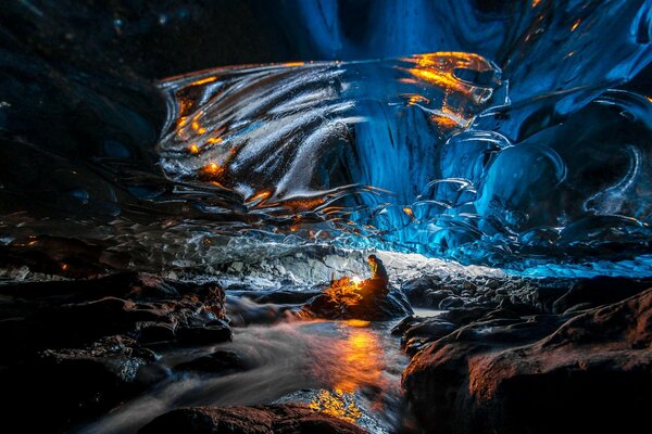 Hombre junto al fuego en una cueva de hielo