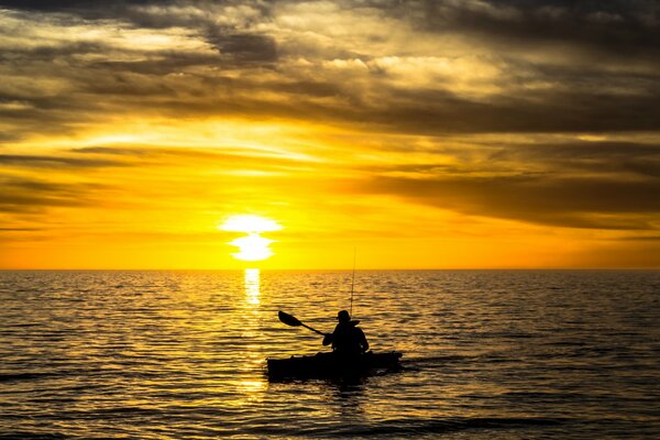 Fishing boat on the background of a river sunset